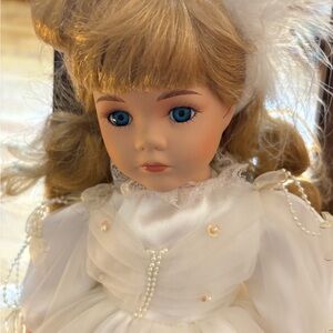 Beautiful porcelain doll in white